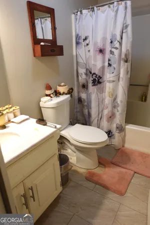 a white toilet sitting next to a bathroom sink