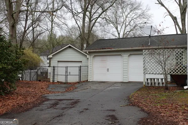 a view of a house with a yard and garage