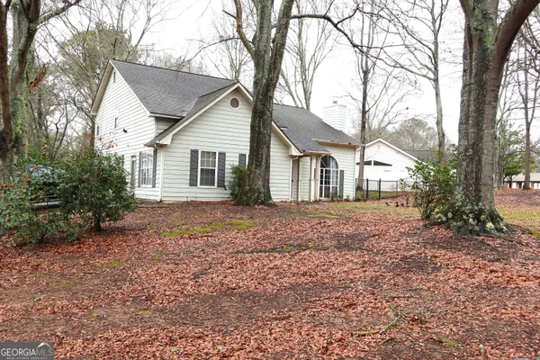 a view of a house with yard and a tree