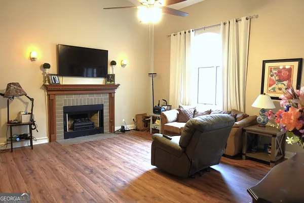 a living room with furniture a flat screen tv and a fireplace