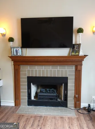a living room with a fireplace and a wooden floor