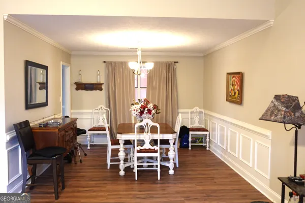 a view of a dining room with furniture and wooden floor