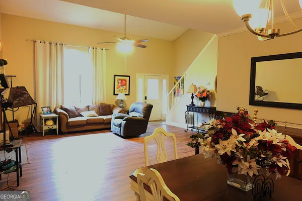 a living room with furniture gym equipment and a chandelier