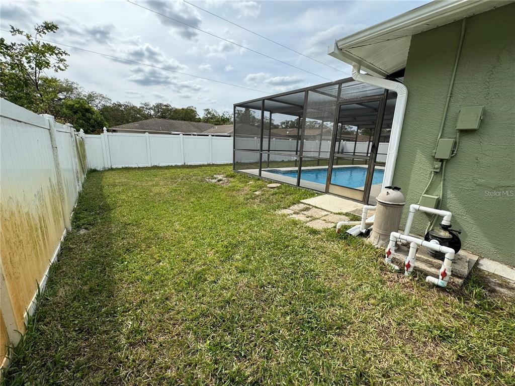 8725 Aruba Lane Port Richey, FL 34668 - Photo 11 of 31 a view of a backyard with sitting area