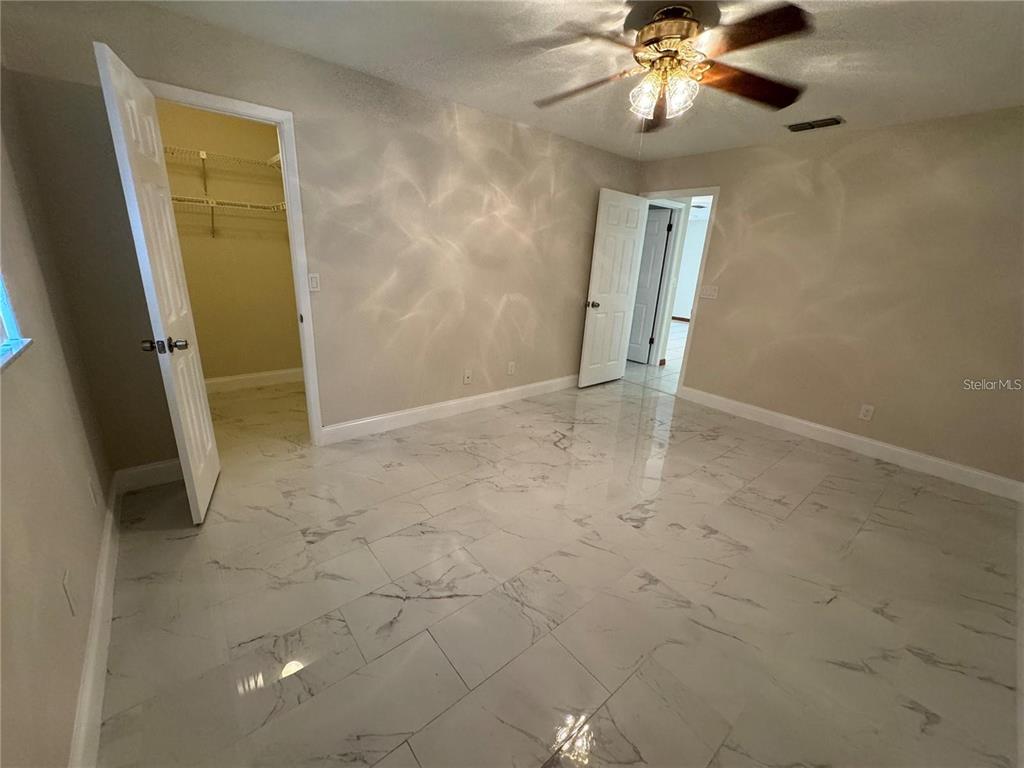 8725 Aruba Lane Port Richey, FL 34668 - Photo 14 of 31 a view of an empty room with a mirror