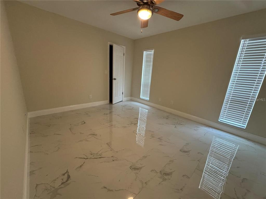 8725 Aruba Lane Port Richey, FL 34668 - Photo 17 of 31 an empty room with windows