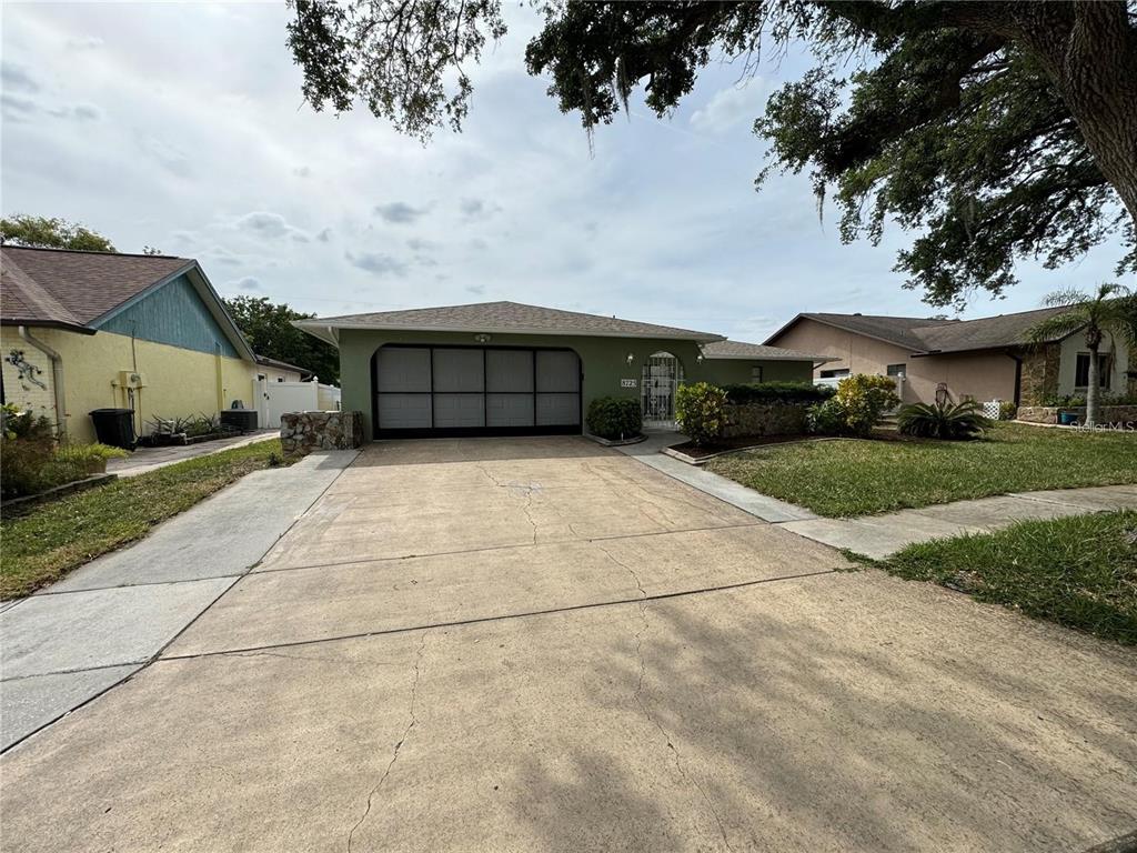 8725 Aruba Lane Port Richey, FL 34668 - Photo 2 of 31 a view of house with yard and car parked