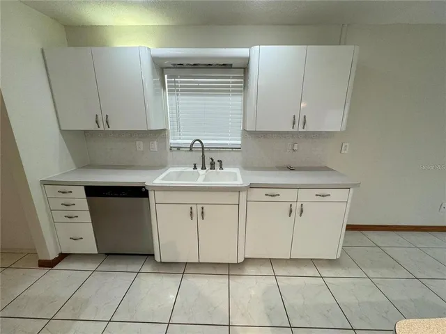 a kitchen with refrigerator and microwave