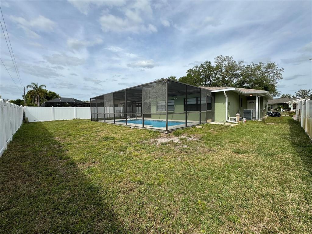 8725 Aruba Lane Port Richey, FL 34668 - Photo 10 of 31 a view of a house with a backyard