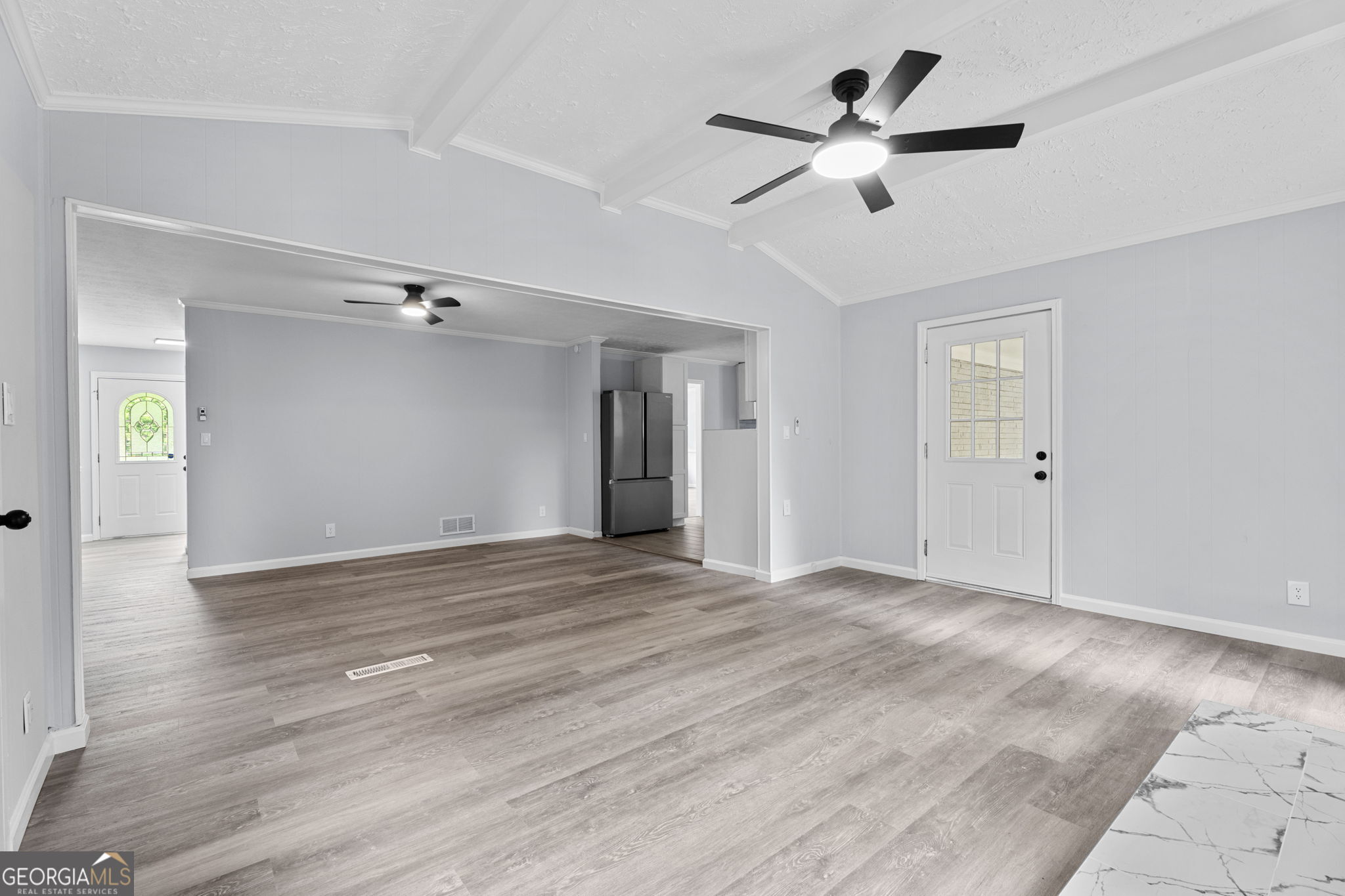 6463 Maddox Road Morrow, GA 30260 - Photo 8 of 46 a view of an empty room with wooden floor and a ceiling fan