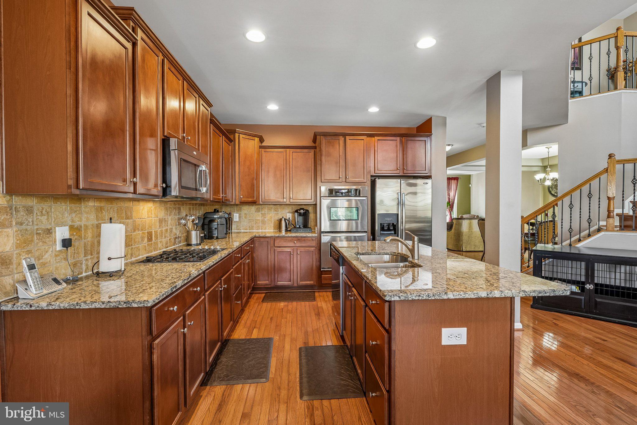 8716 Raleigh Mews Gainesville, VA 20155 - Photo 11 of 37 Warm, inviting kitchen with rich wood.