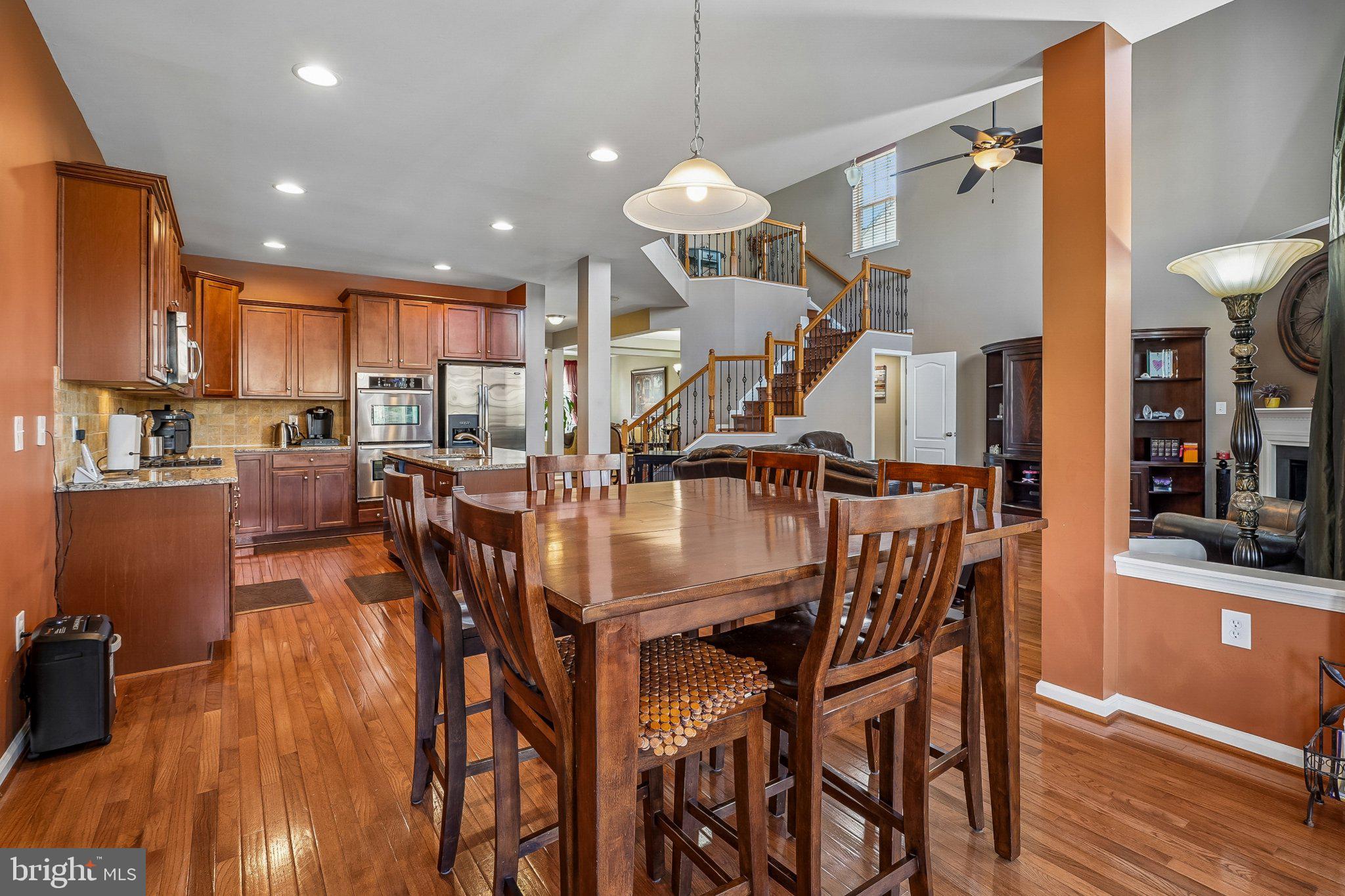 8716 Raleigh Mews Gainesville, VA 20155 - Photo 14 of 37 Spacious kitchen with warm wood tones.