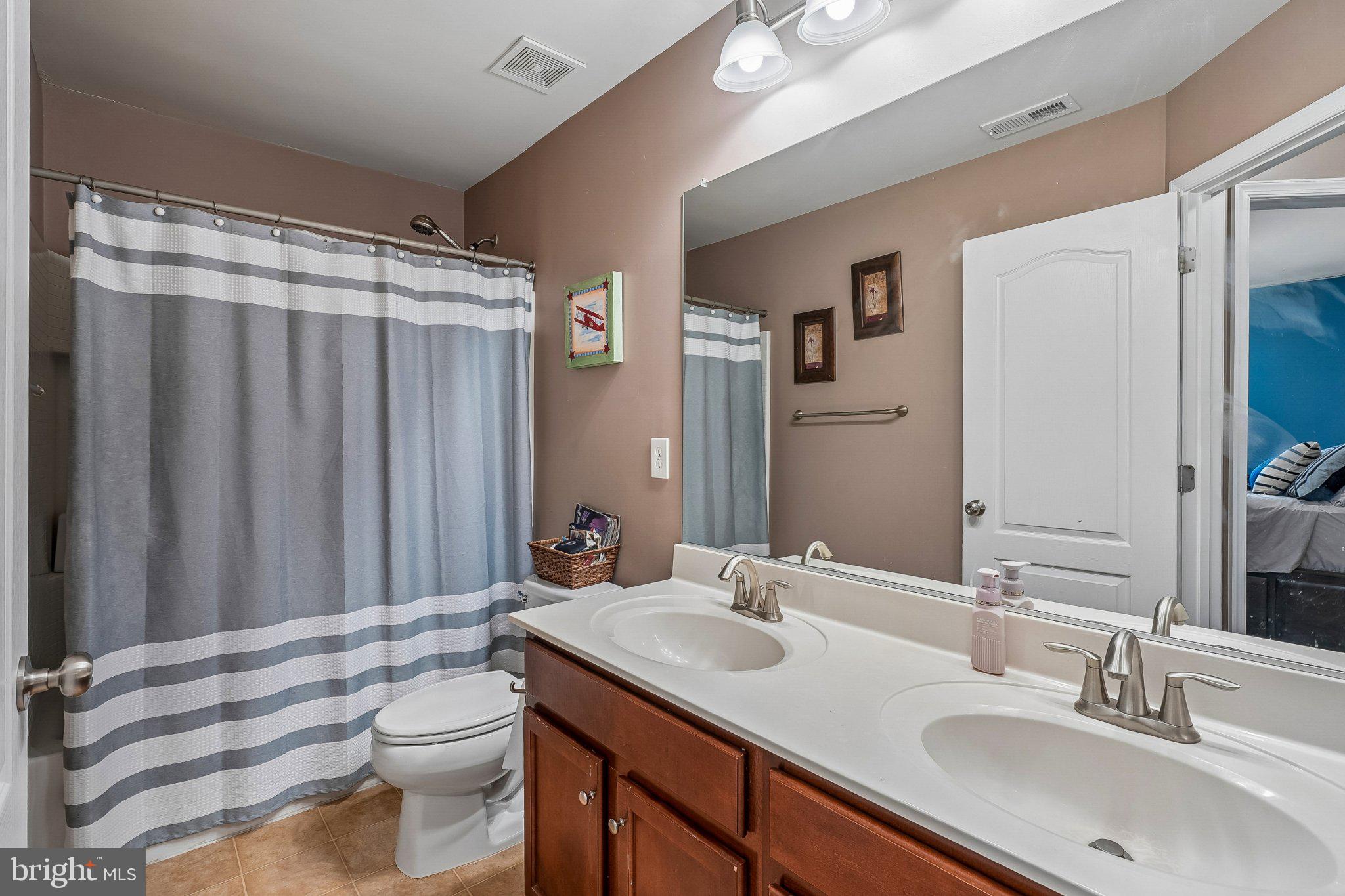 8716 Raleigh Mews Gainesville, VA 20155 - Photo 26 of 37 Modern bathroom with dual sinks.