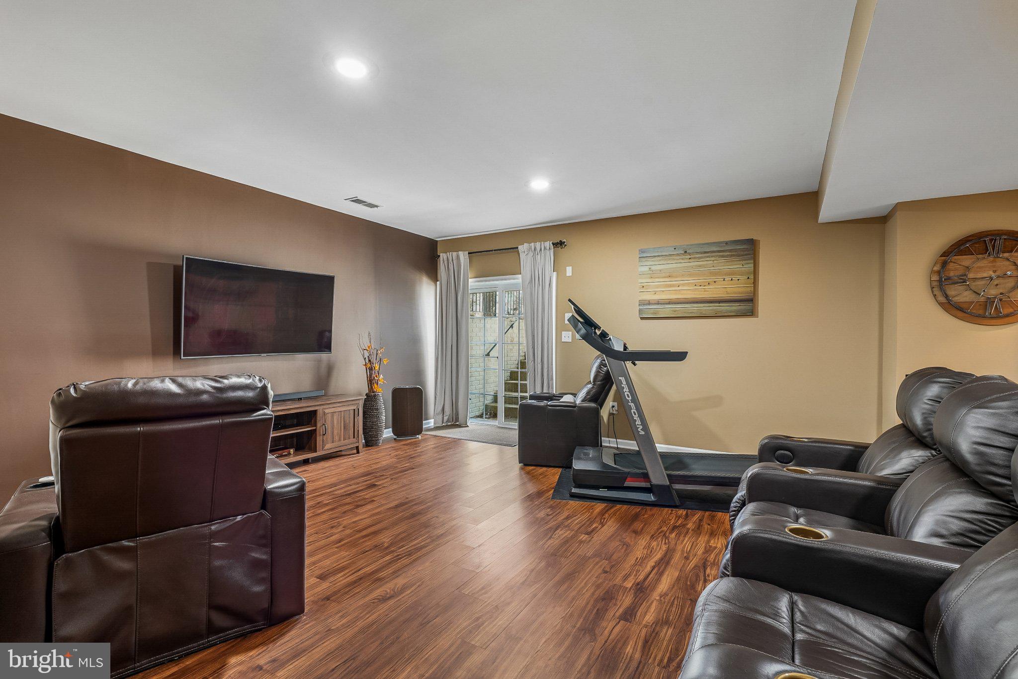 8716 Raleigh Mews Gainesville, VA 20155 - Photo 30 of 37 Rec Room with cozy ambiance. Walk up sliding door