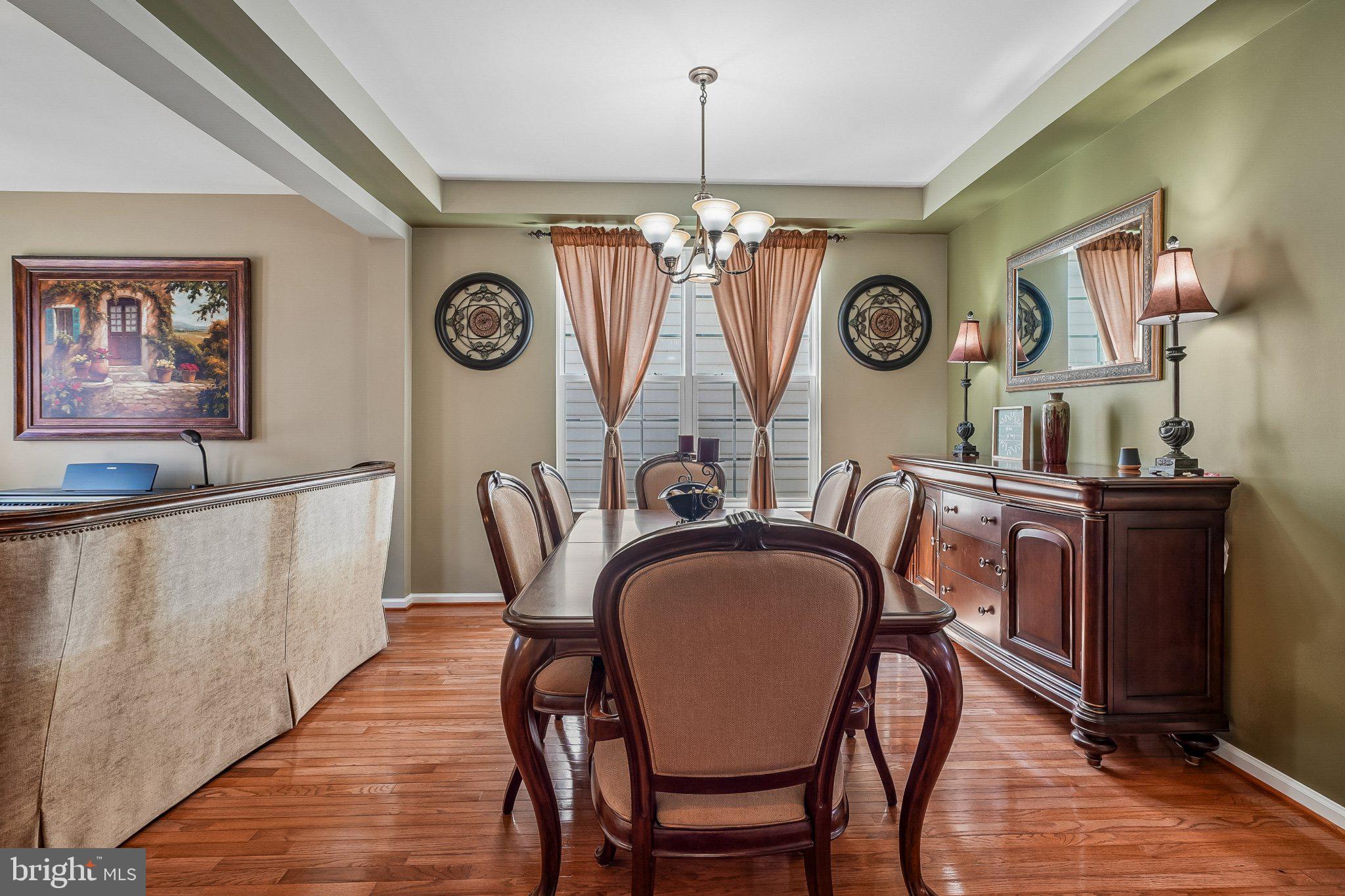 8716 Raleigh Mews Gainesville, VA 20155 - Photo 8 of 37 Elegant dining space with warm tones.