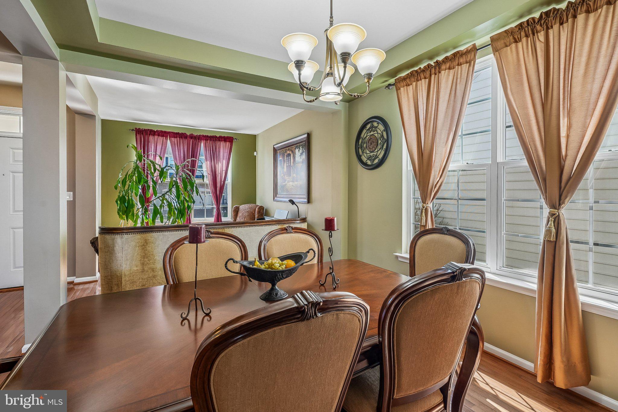 8716 Raleigh Mews Gainesville, VA 20155 - Photo 9 of 37 Elegant dining space with natural light.