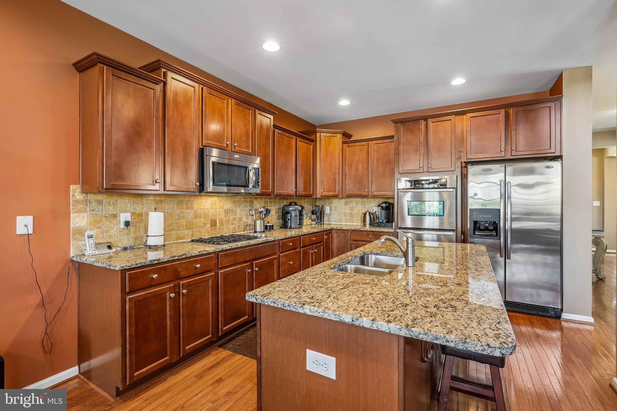 8716 Raleigh Mews Gainesville, VA 20155 - Photo 10 of 37 Warm-toned kitchen with modern finishes.