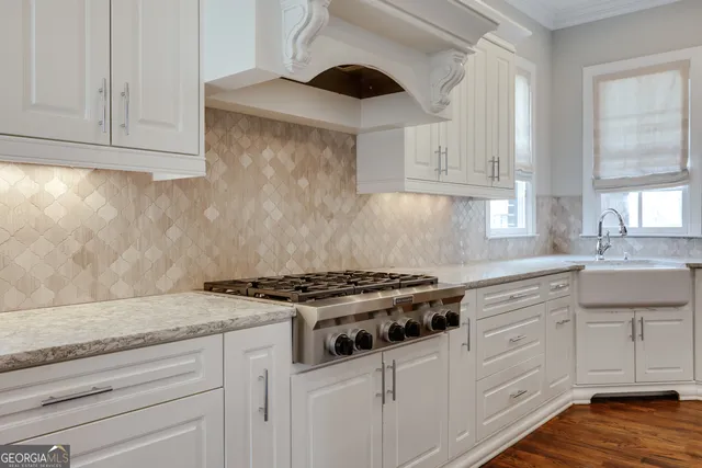 a kitchen with cabinets and wooden floor
