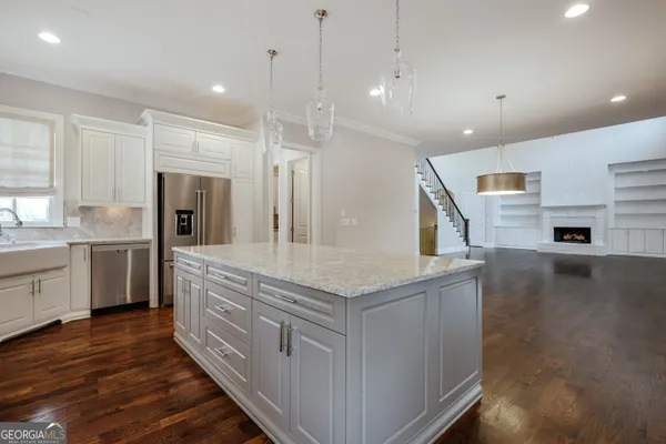 a dining room with furniture wooden floor a chandelier and a rug