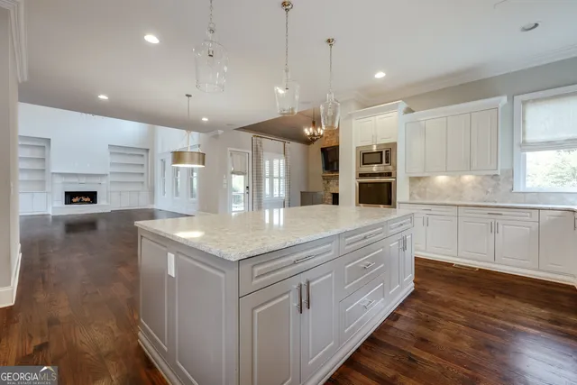 a bathroom with a granite countertop sink and a toilet