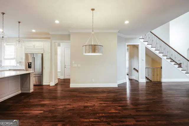 a spacious bathroom with a double vanity sink mirror and bathtub