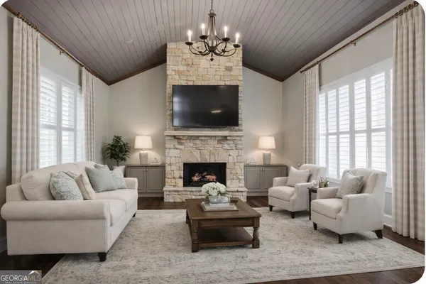 a bedroom with a bed couch and large windows
