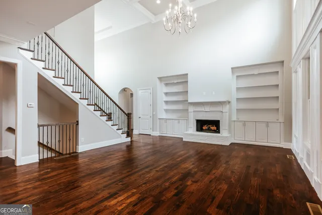 a spacious bathroom with a double vanity sink a mirror and a bathtub