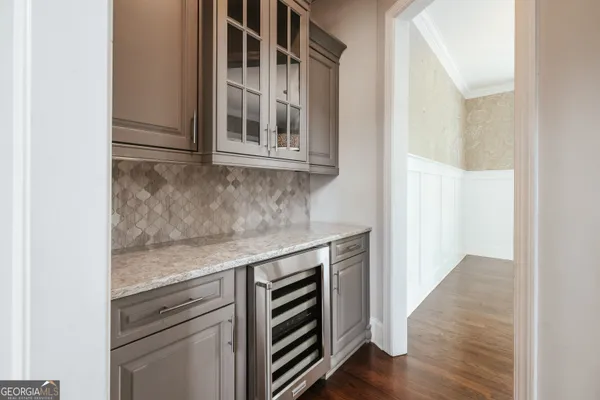 a view of a kitchen with a sink and a refrigerator