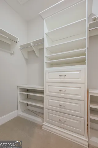 a view of a livingroom with a ceiling fan and window