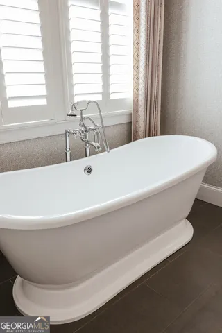 a view of a livingroom with a ceiling fan and window