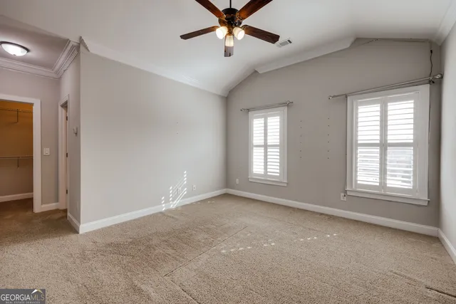 a view of a livingroom with a ceiling fan and window