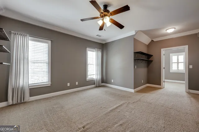 a living room with furniture and a ceiling fan