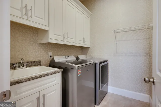 a kitchen with granite countertop a sink stove and cabinets