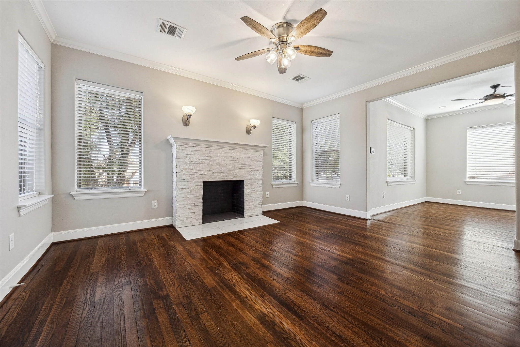 2618 Cleburne Street Houston, TX 77004 - Photo 11 of 25 an empty room with wooden floor fireplace and windows