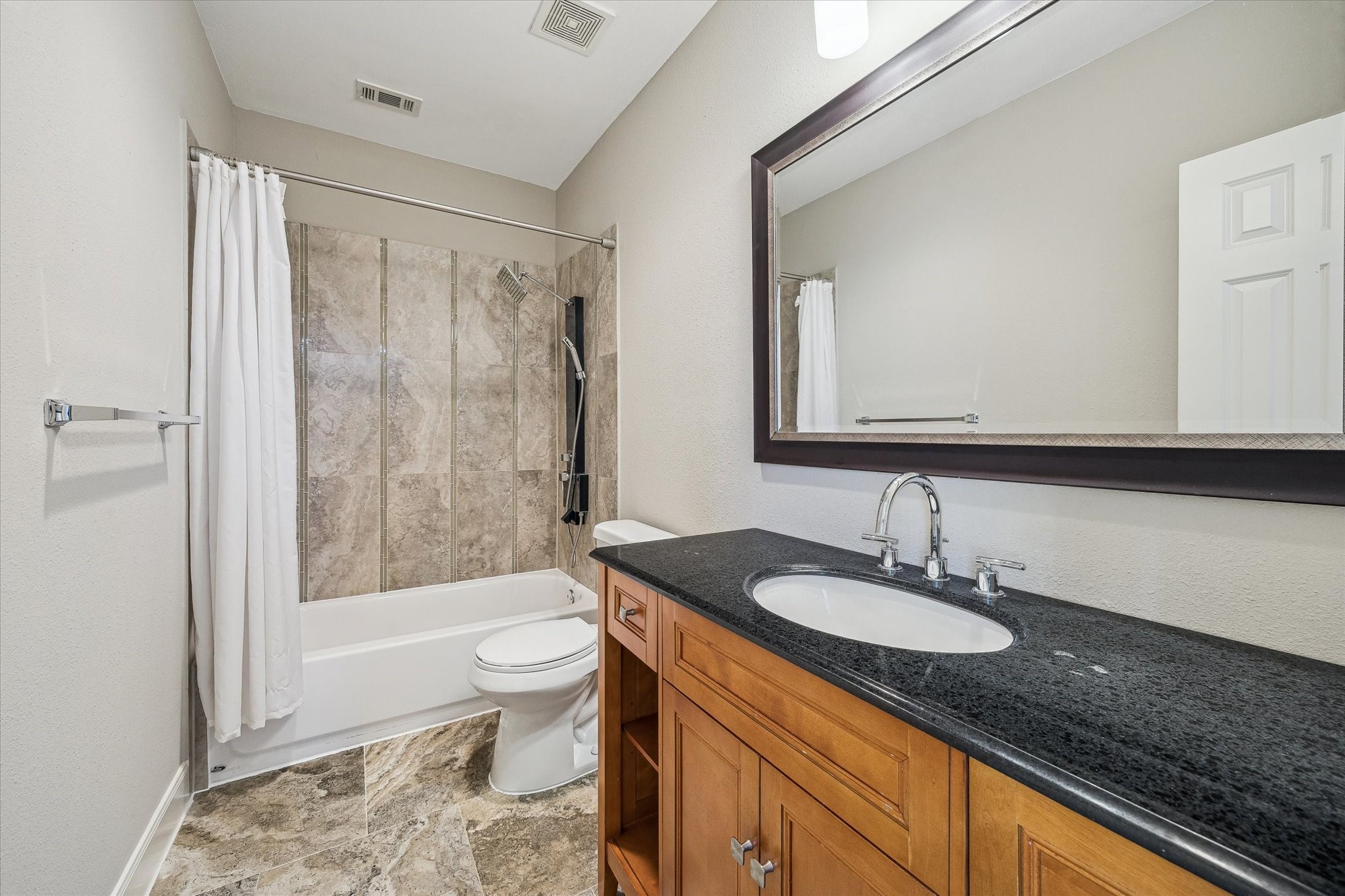 2618 Cleburne Street Houston, TX 77004 - Photo 19 of 25 a bathroom with a granite countertop sink toilet and shower