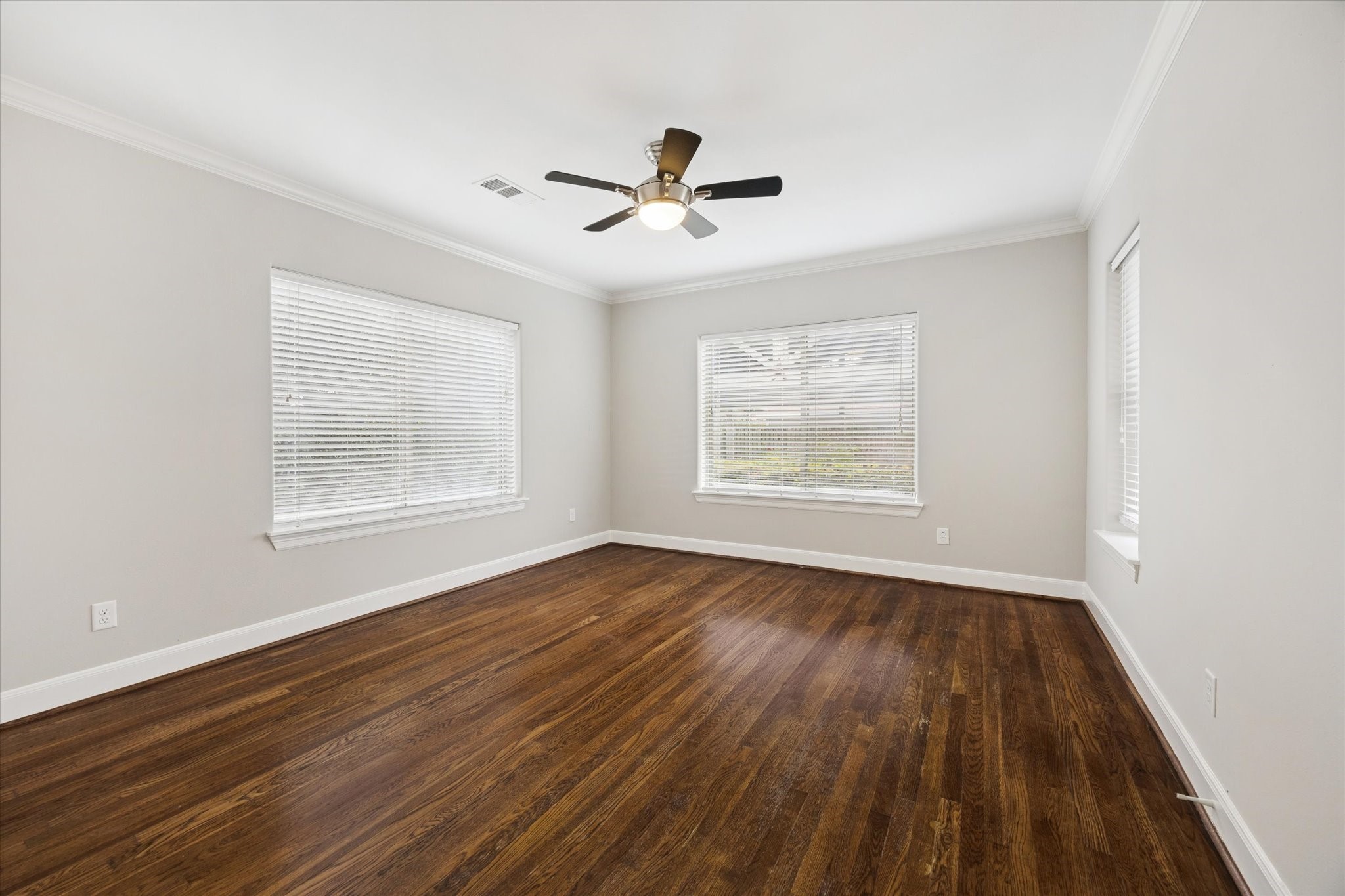 2618 Cleburne Street Houston, TX 77004 - Photo 22 of 25 a view of an empty room with wooden floor and a window