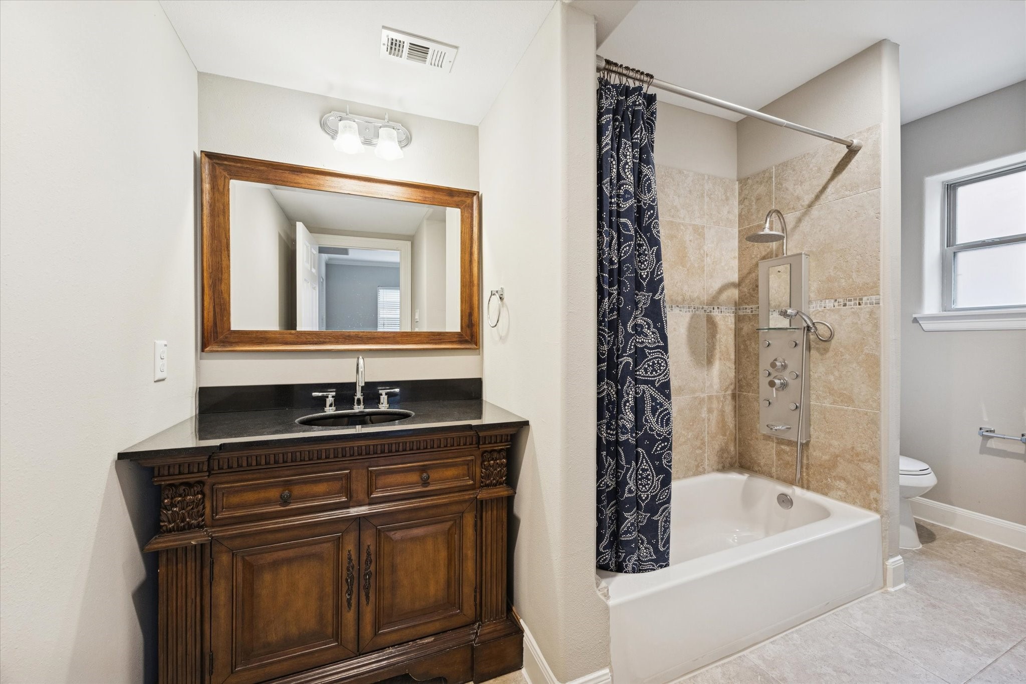 2618 Cleburne Street Houston, TX 77004 - Photo 24 of 25 a bathroom with a bathtub a sink and a mirror