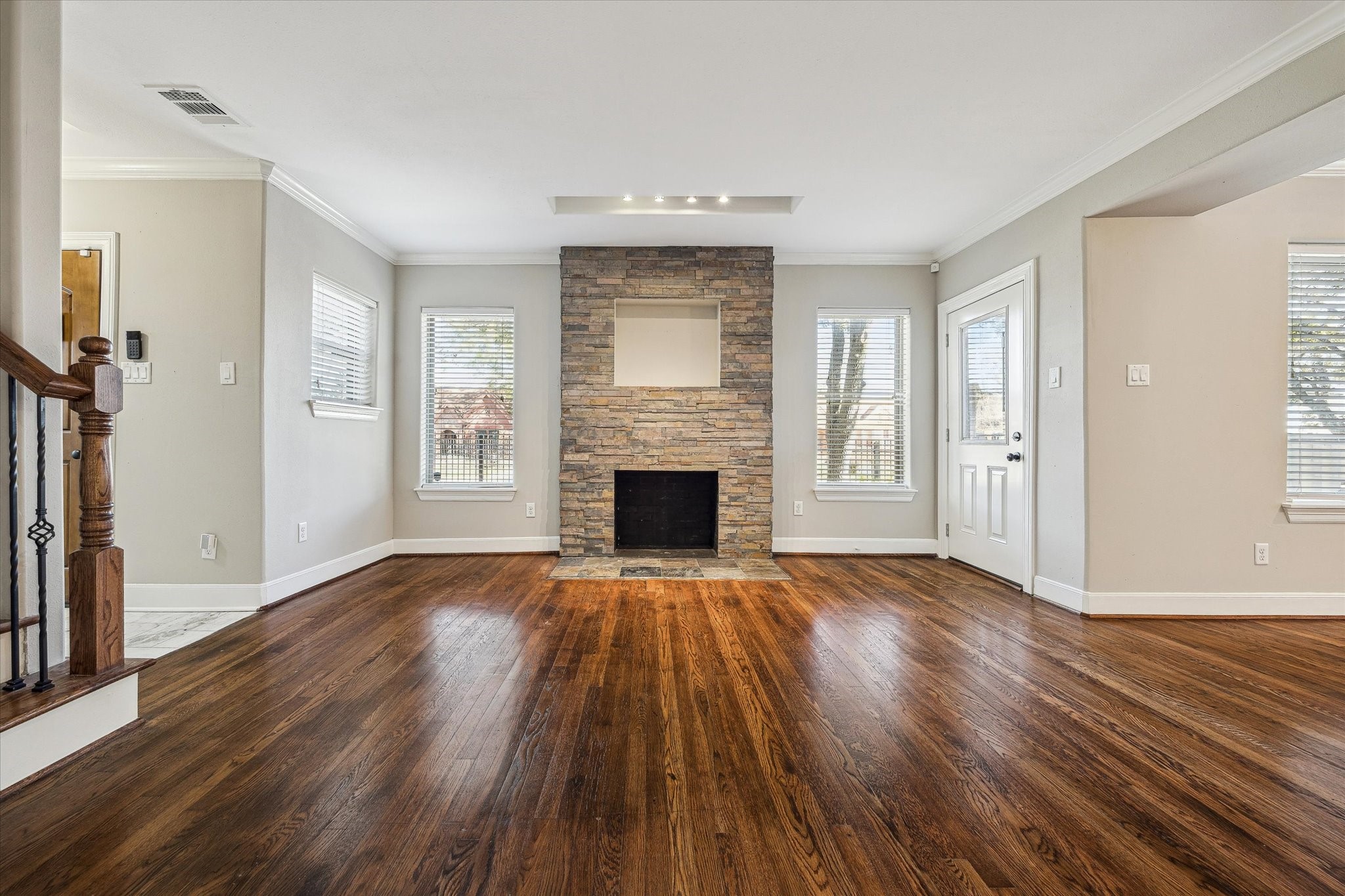 2618 Cleburne Street Houston, TX 77004 - Photo 5 of 25 an empty room with wooden floor fireplace and windows