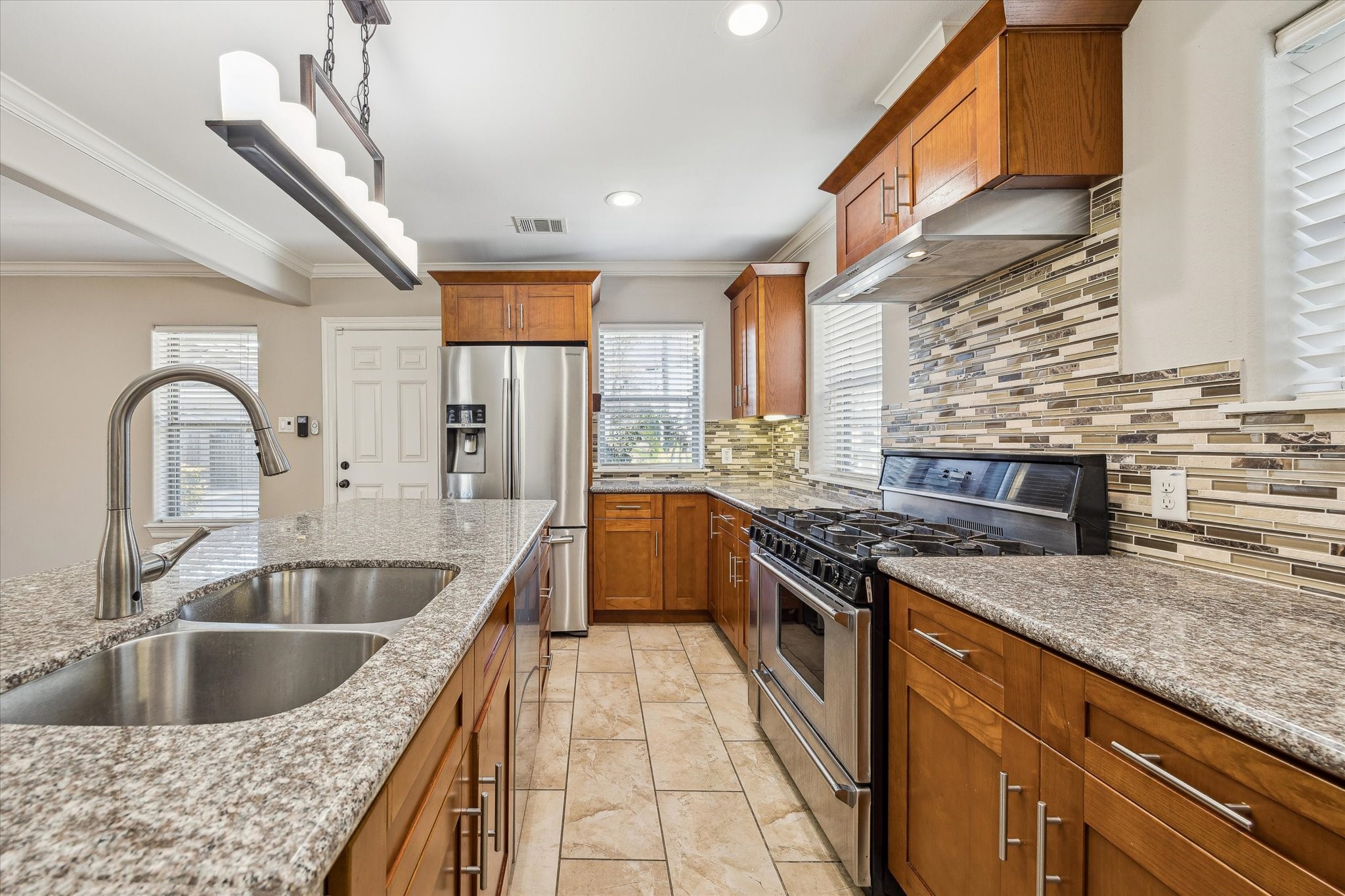 2618 Cleburne Street Houston, TX 77004 - Photo 7 of 25 a kitchen with stainless steel appliances granite countertop a sink stove and cabinets