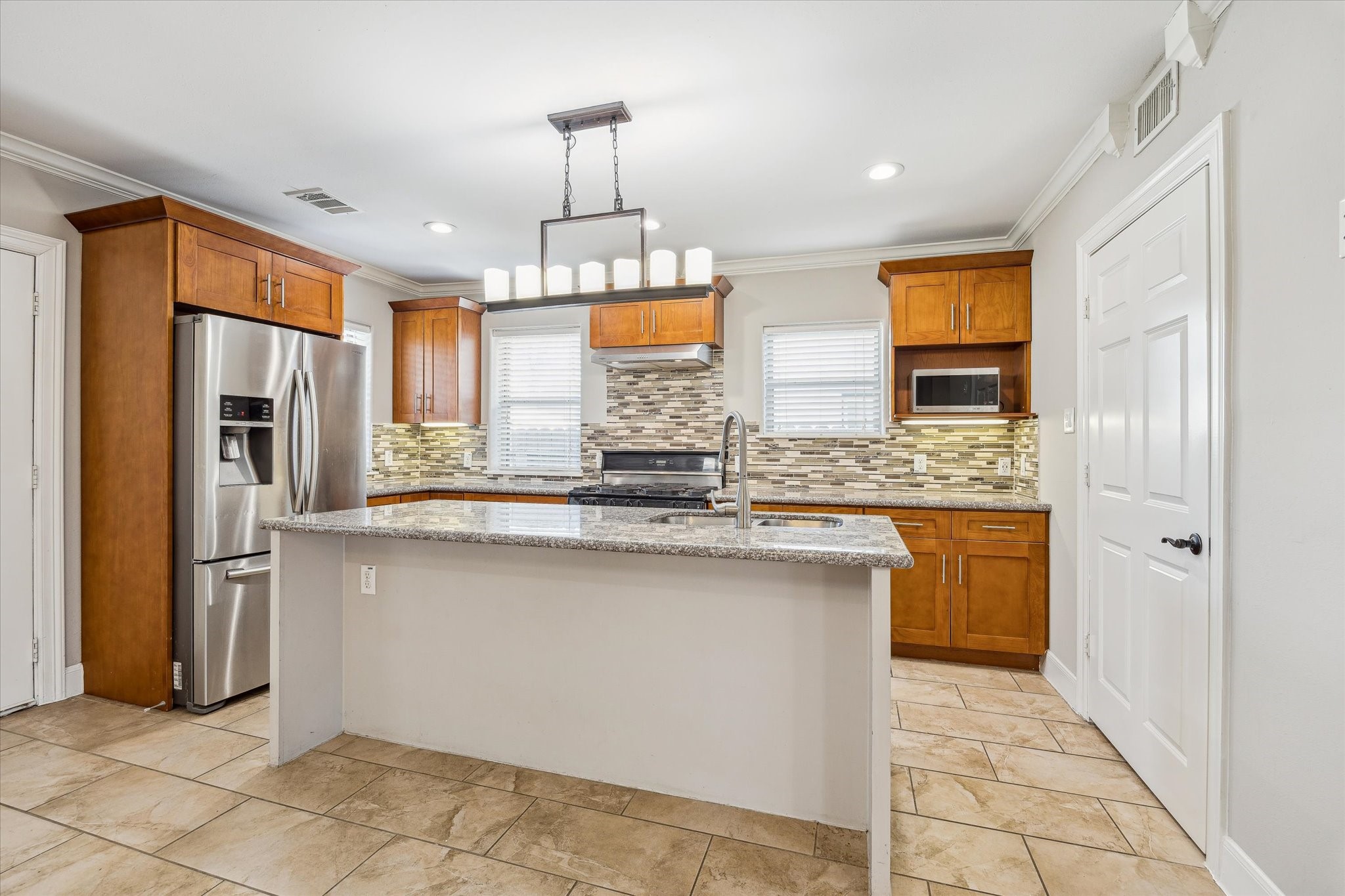 2618 Cleburne Street Houston, TX 77004 - Photo 8 of 25 a kitchen with stainless steel appliances granite countertop a sink a stove a refrigerator and cabinets