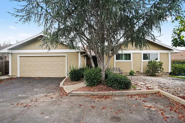 a front view of a house with a yard and a garage