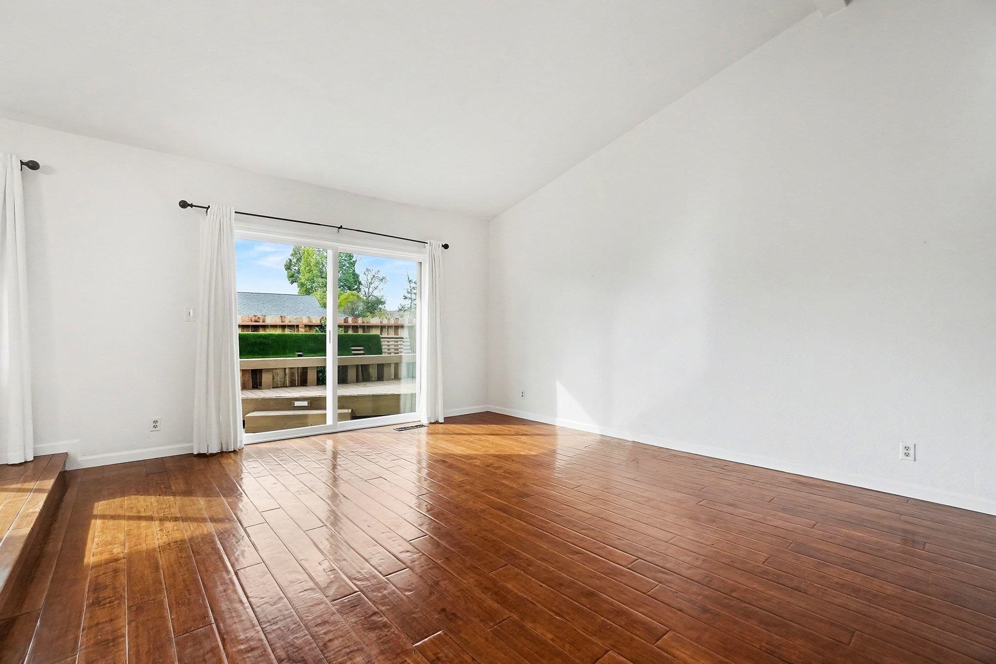 1833 Camino Estrada Concord, CA 94521 - Photo 11 of 25 a view of an empty room with wooden floor and a window