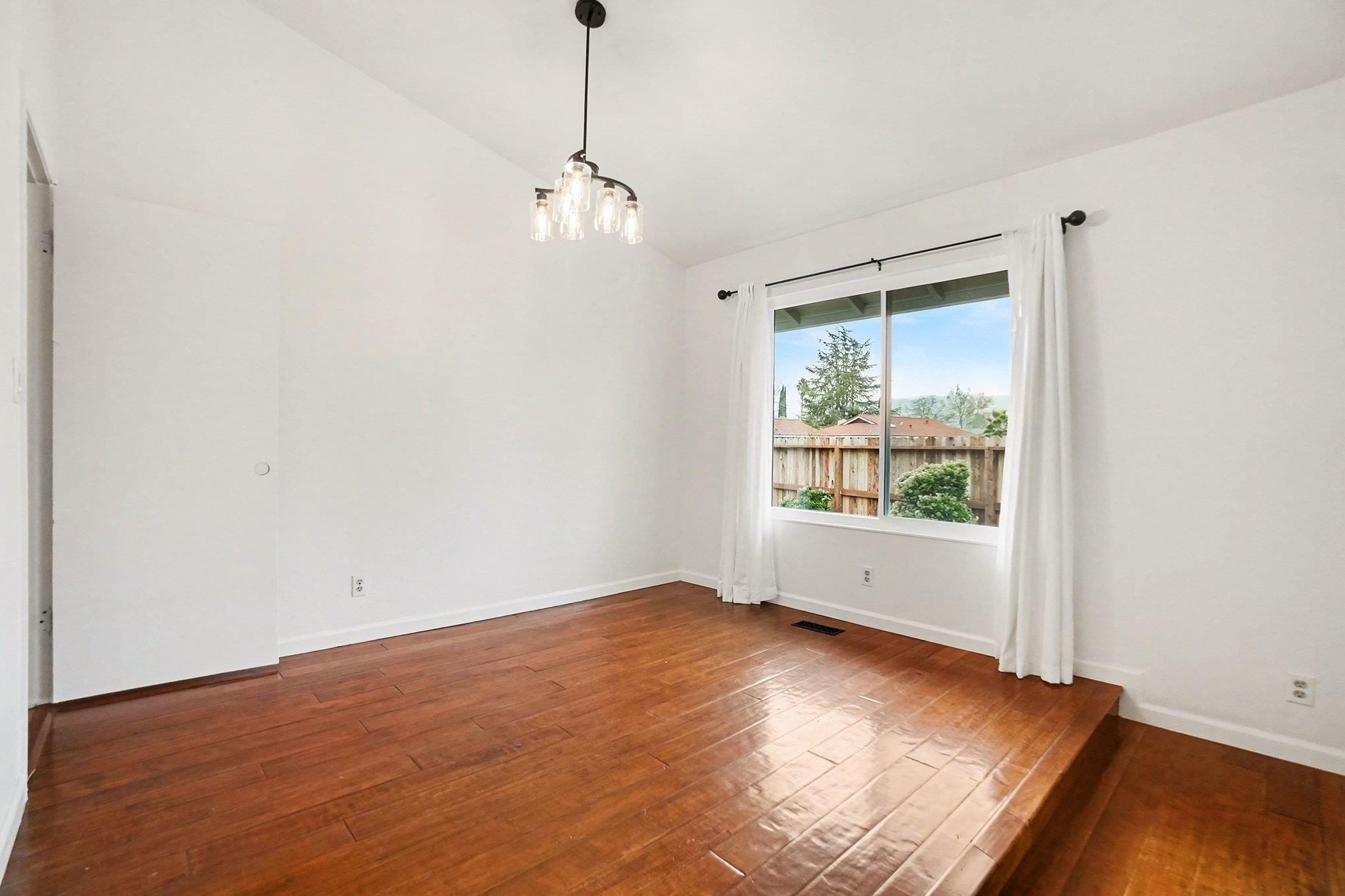 1833 Camino Estrada Concord, CA 94521 - Photo 12 of 25 a view of empty room with wooden floor and fan
