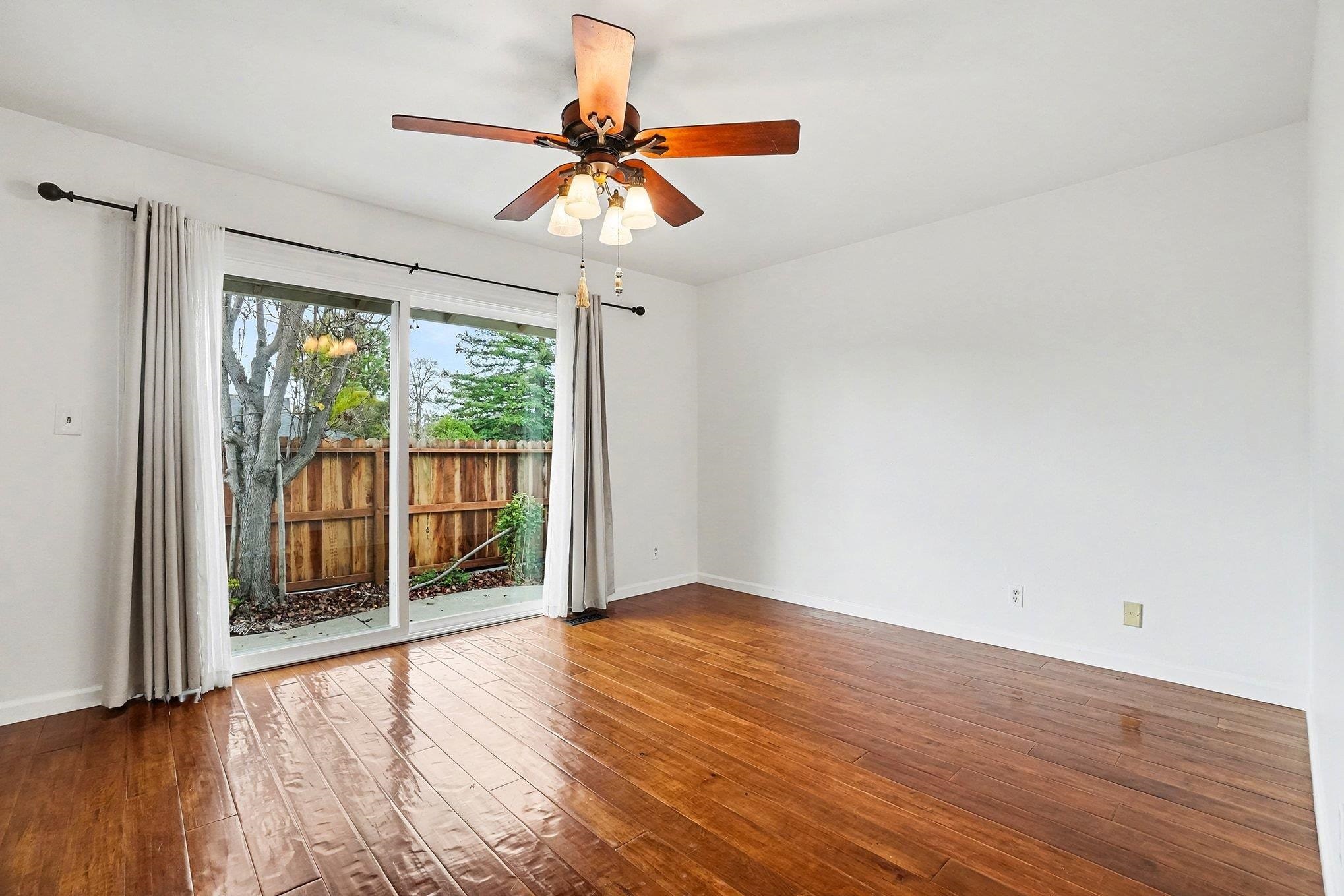 1833 Camino Estrada Concord, CA 94521 - Photo 13 of 25 a view of an empty room with wooden floor and a window