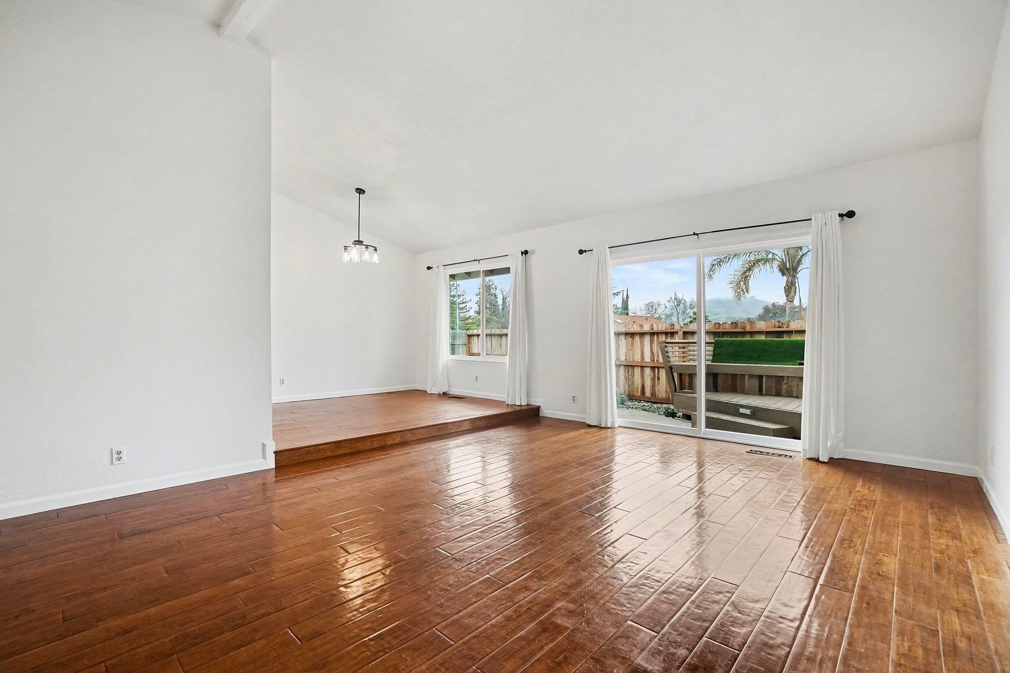 1833 Camino Estrada Concord, CA 94521 - Photo 8 of 25 an empty room with wooden floor and windows