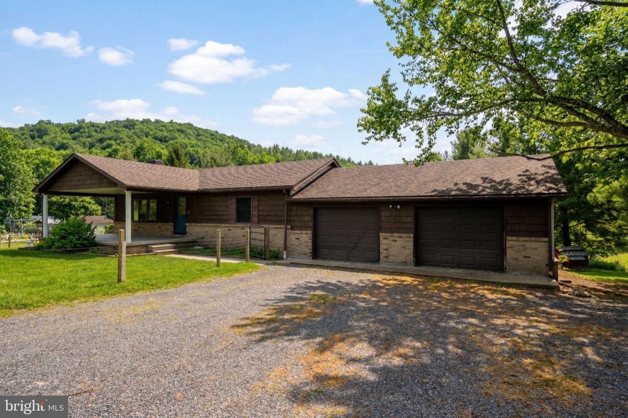 a house with lots of trees in the background