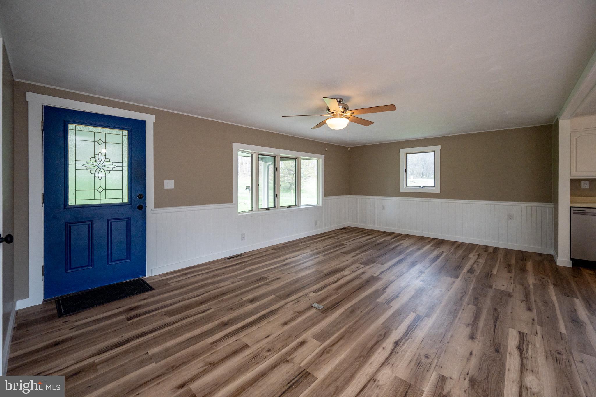 2571 Shady Dell Road Oakland, MD 21550 - Photo 3 of 60 a view of an empty room with a window and wooden floor