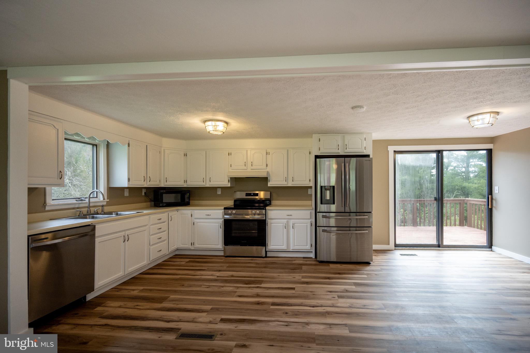 2571 Shady Dell Road Oakland, MD 21550 - Photo 7 of 60 a kitchen with a refrigerator and a stove top oven