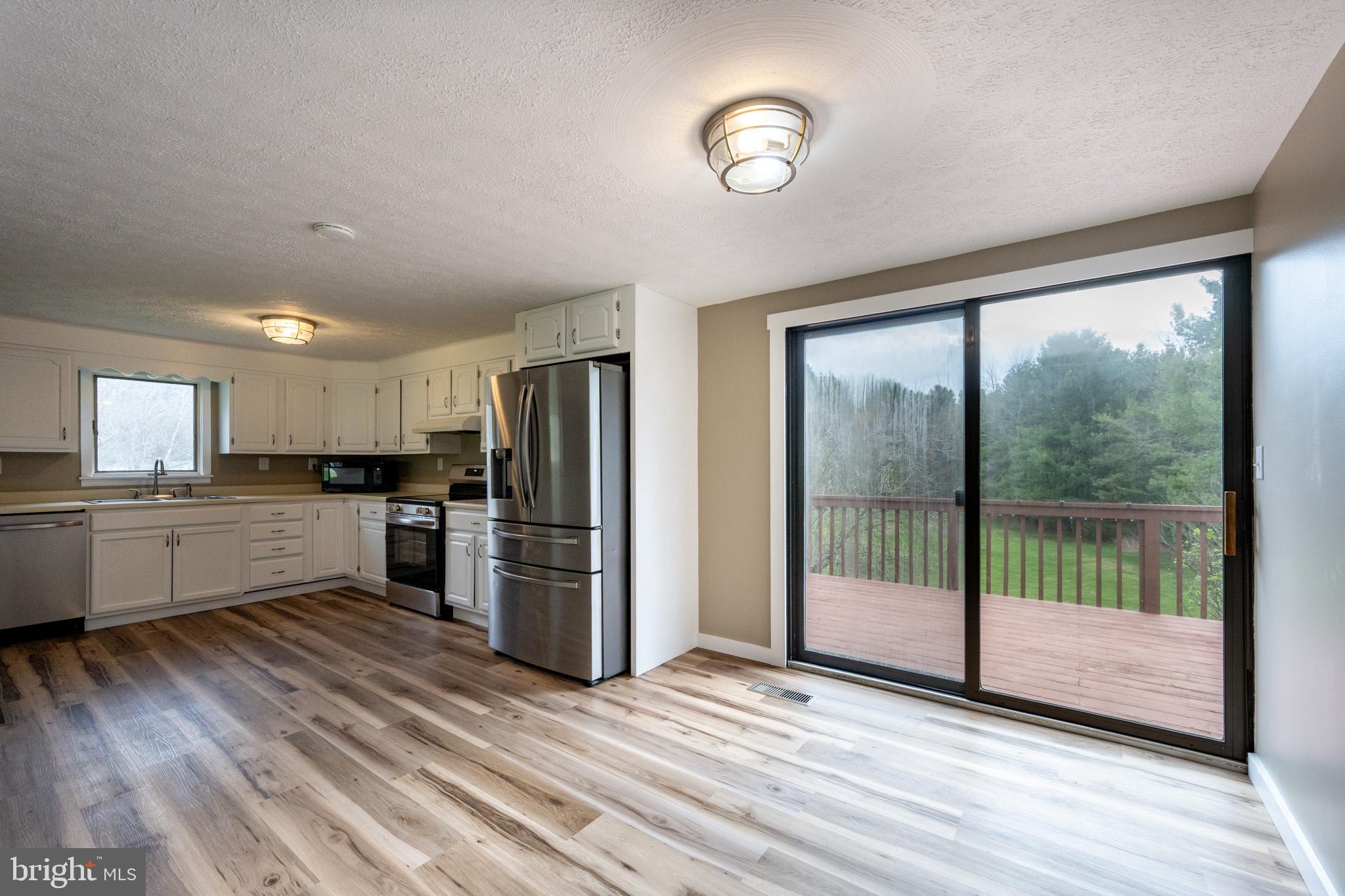 2571 Shady Dell Road Oakland, MD 21550 - Photo 10 of 60 a view of kitchen with refrigerator microwave and stove