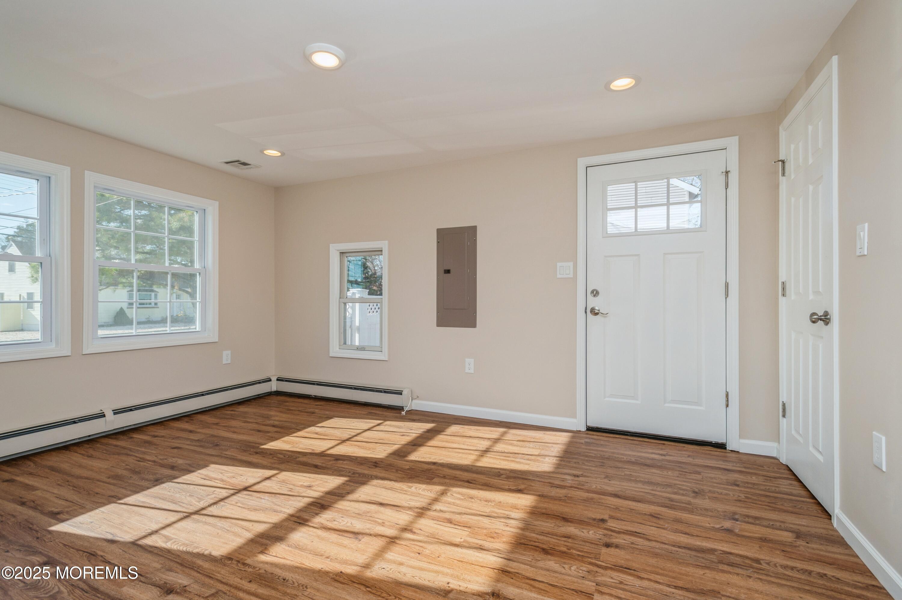 59 Harbor Inn Road Bayville, NJ 08721 - Photo 10 of 25 a view of an empty room with wooden floor and a window